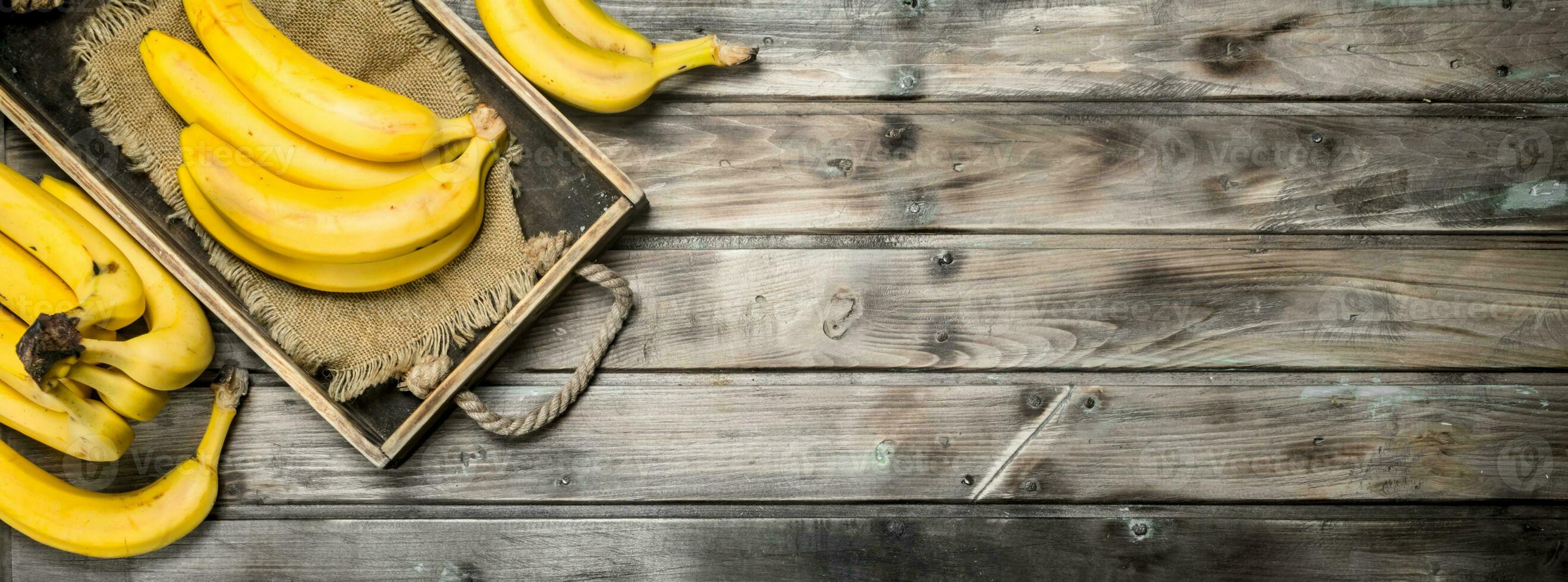 Fresh bananas on the bag in the old dressing. photo