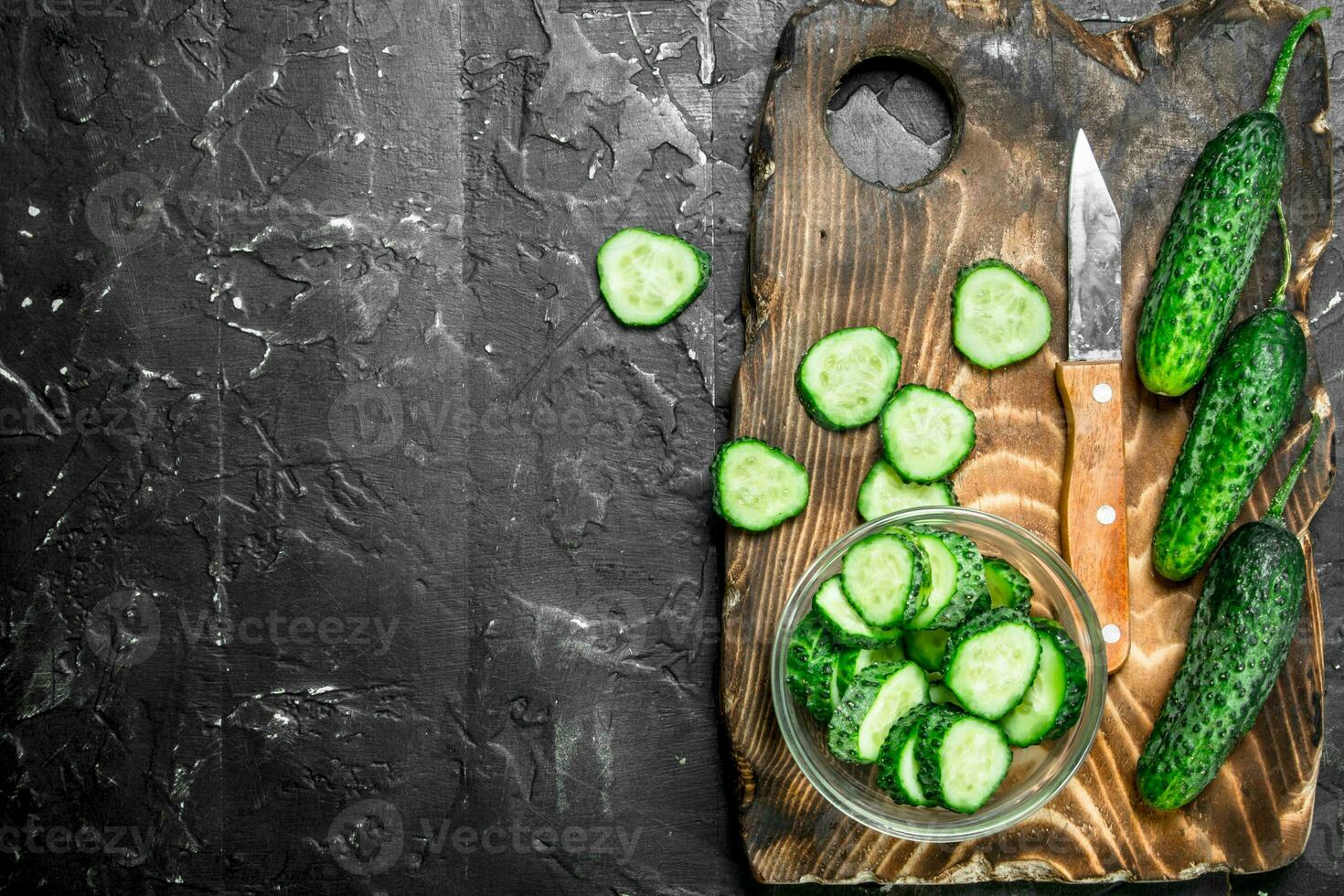 Sliced cucumbers on a cutting Board with a knife. photo