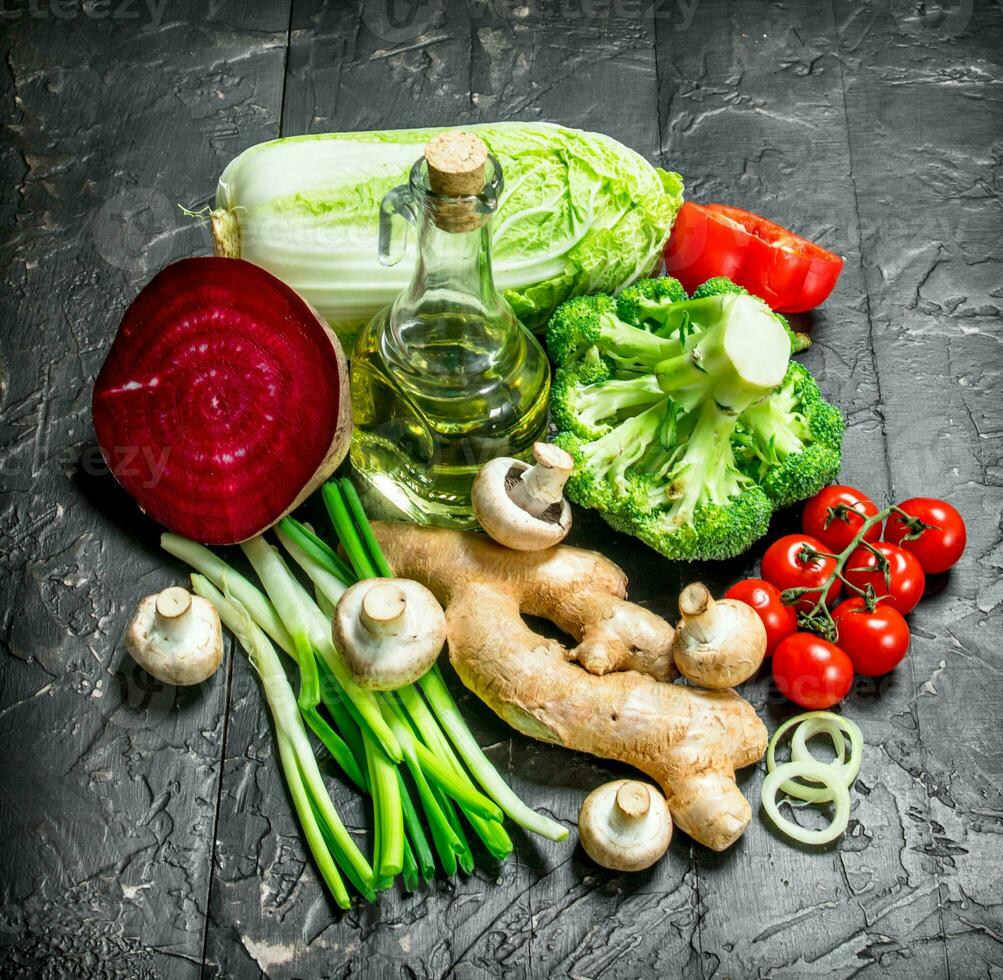 Organic food. Ripe vegetables with a bottle of olive oil. photo