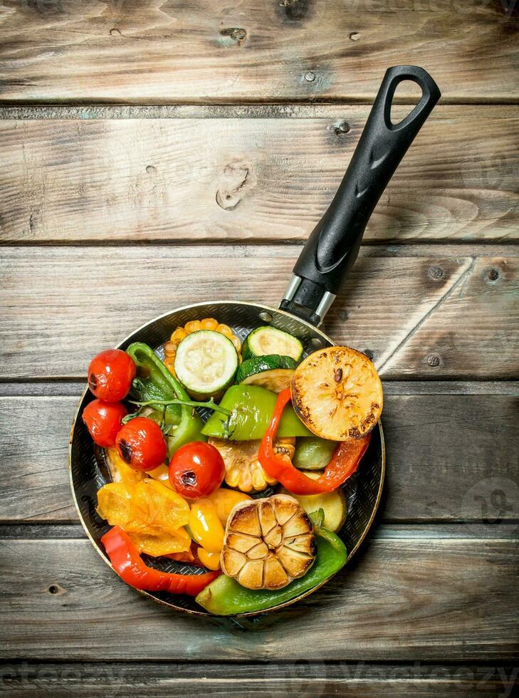 Different grilled vegetables with herbs and spices. photo