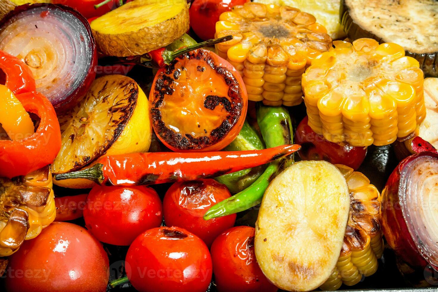 Different grilled vegetables with herbs and spices. photo