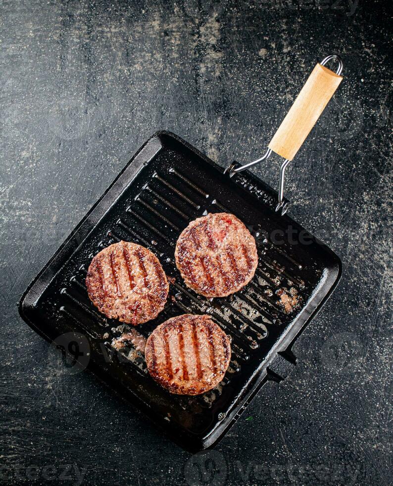 Grilled burger in a frying pan. photo
