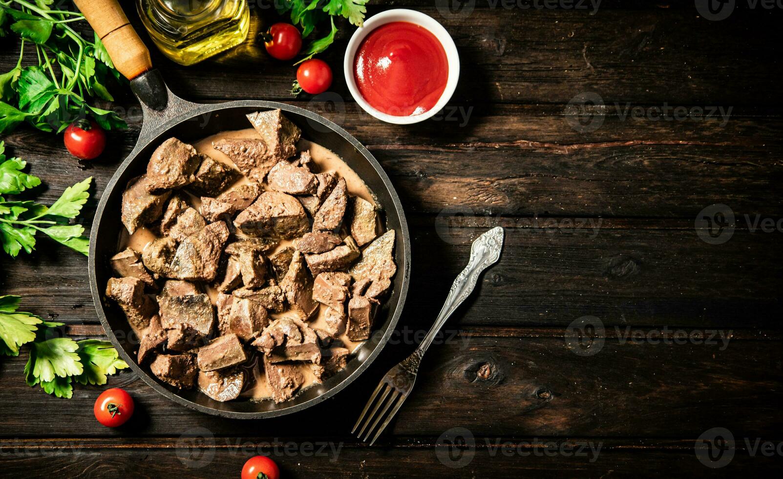 A frying pan with cooked liver on the table. photo