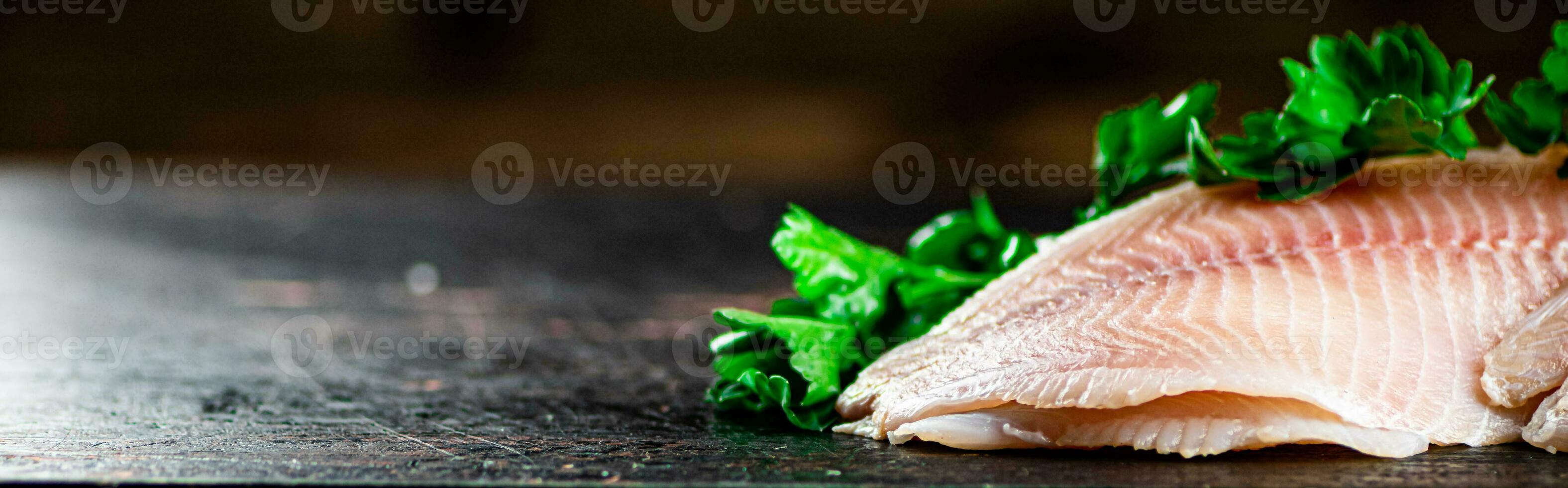 Raw fish fillet with parsley. photo