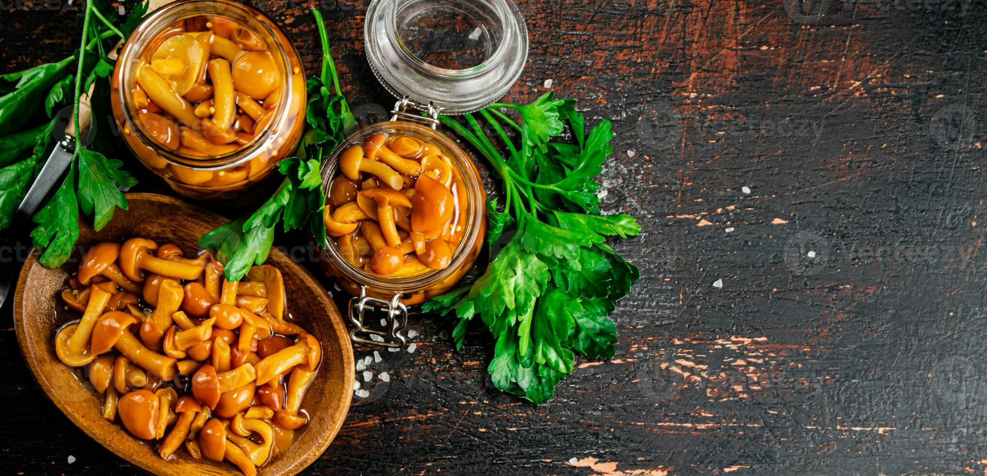 Delicious marinated mushrooms in a jar and on a plate. photo