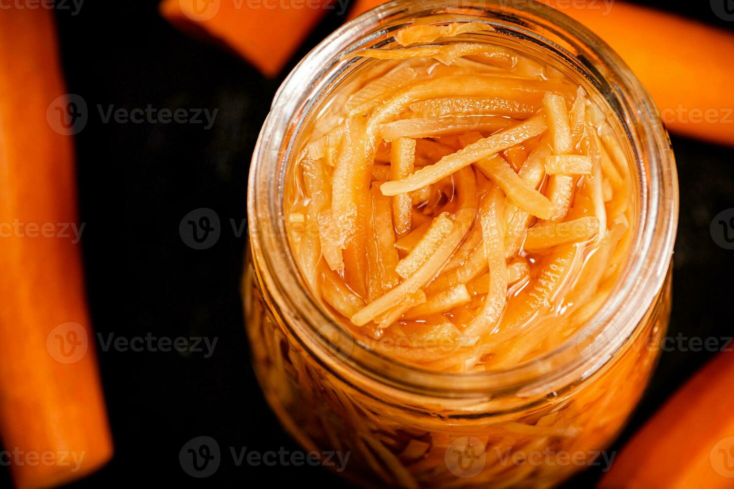 Canned carrots in a glass jar. photo