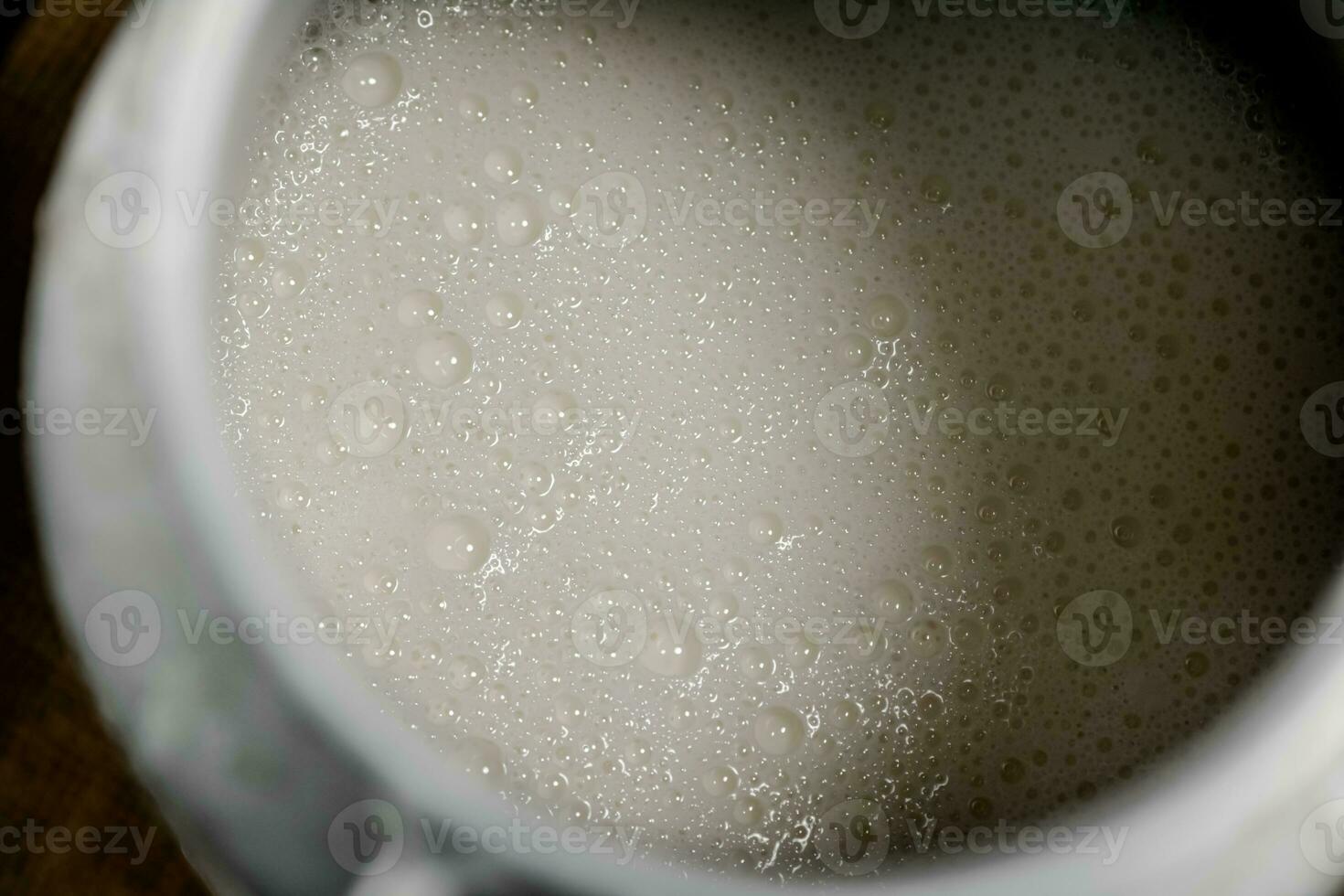 Village milk in a can. Macro background. photo
