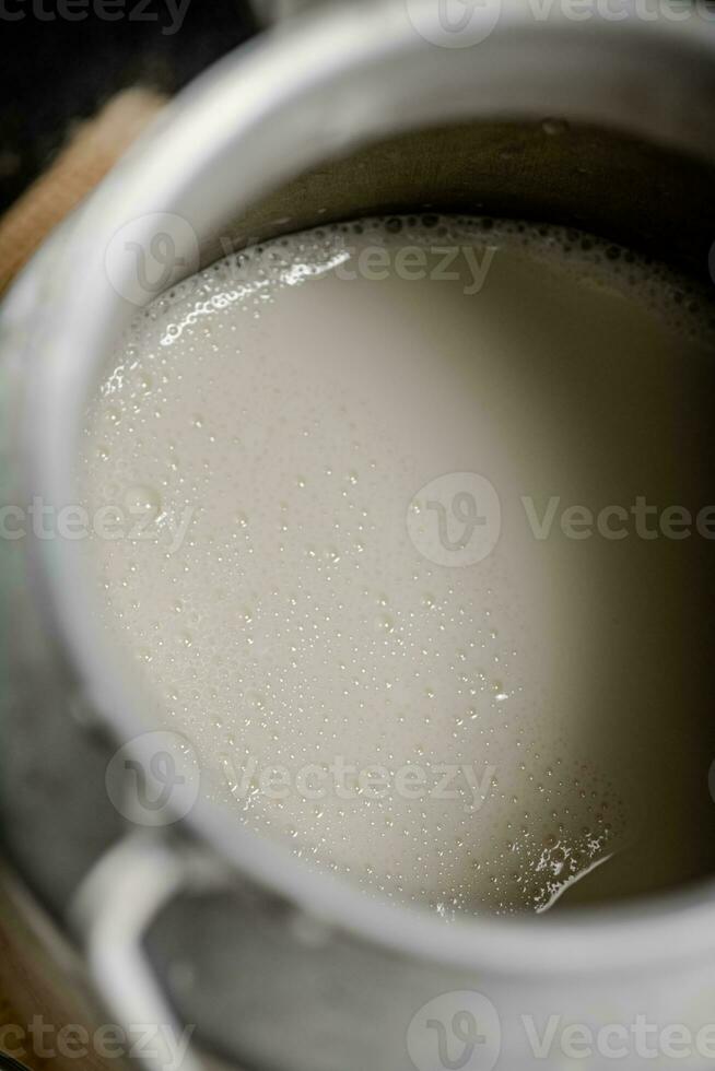 Village milk in a can. Macro background. photo