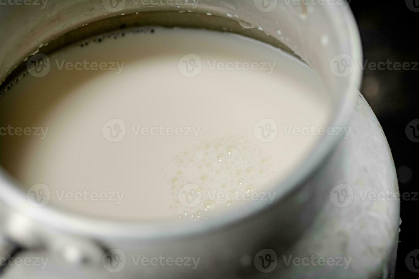 Fresh milk in a can on the table. photo