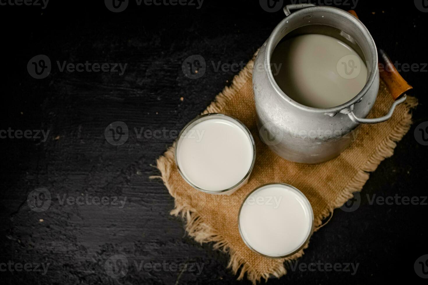Fresh milk in a can on the table. photo