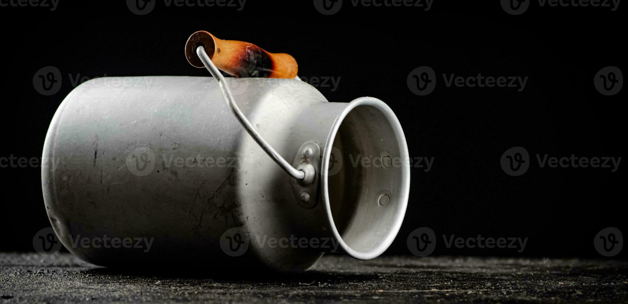 An empty milk can on the table. photo