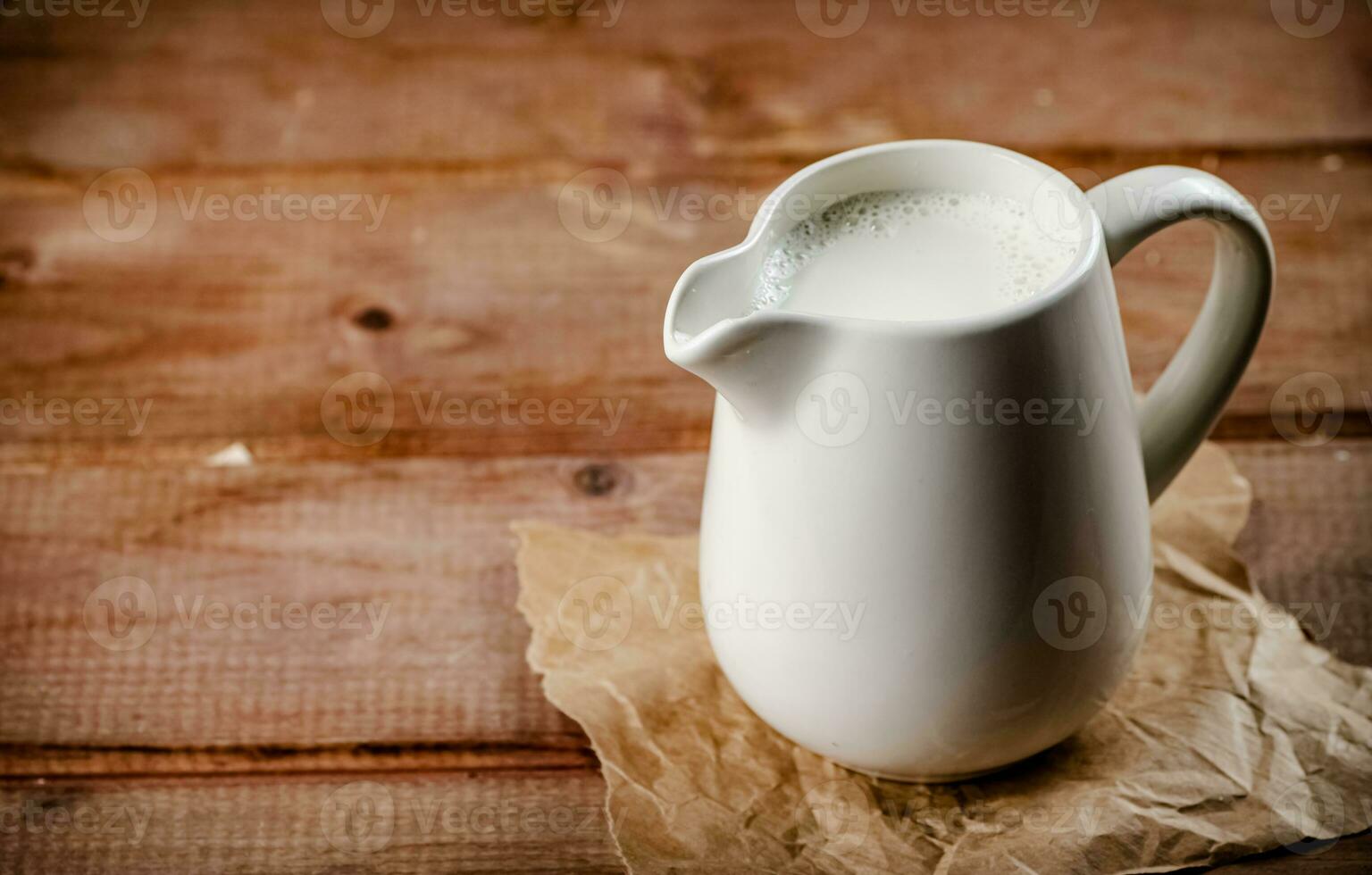 A jug of fresh milk on the table. photo
