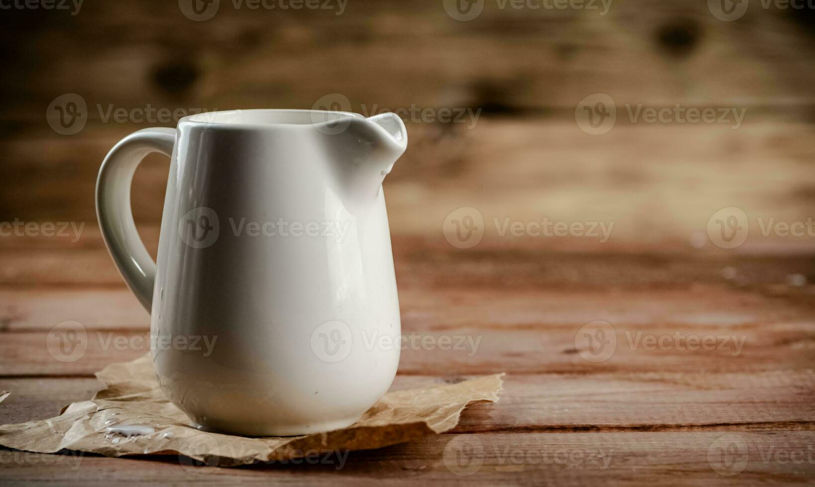 A jug of fresh milk on the table. photo