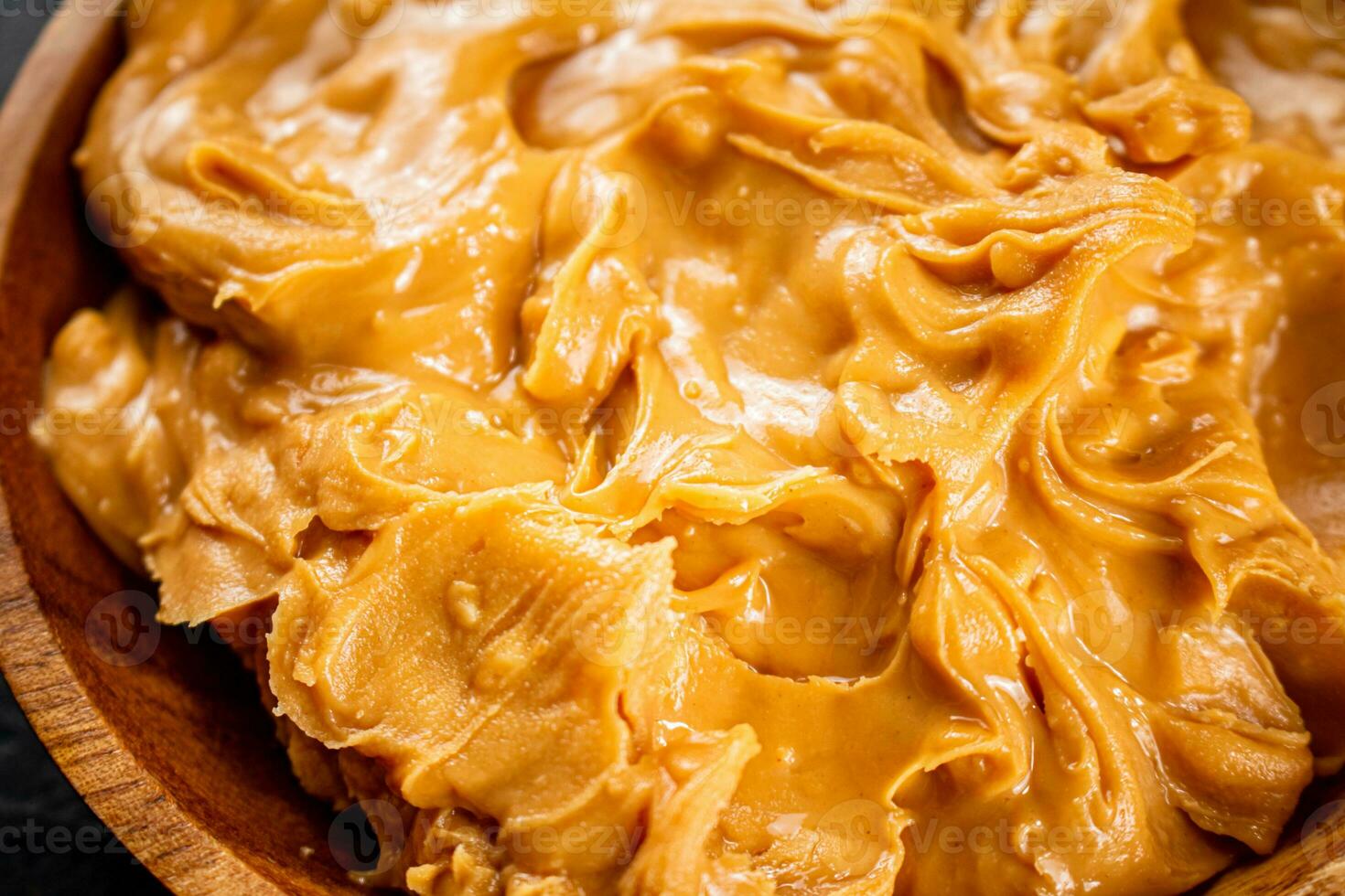 Peanut butter on a plate. Macro background. photo
