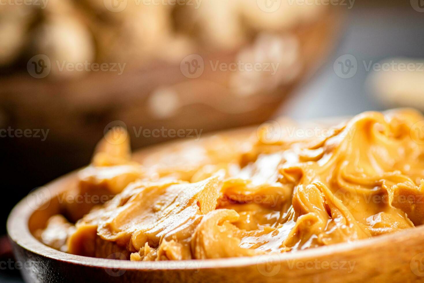 Peanut butter on a plate. Macro background. photo