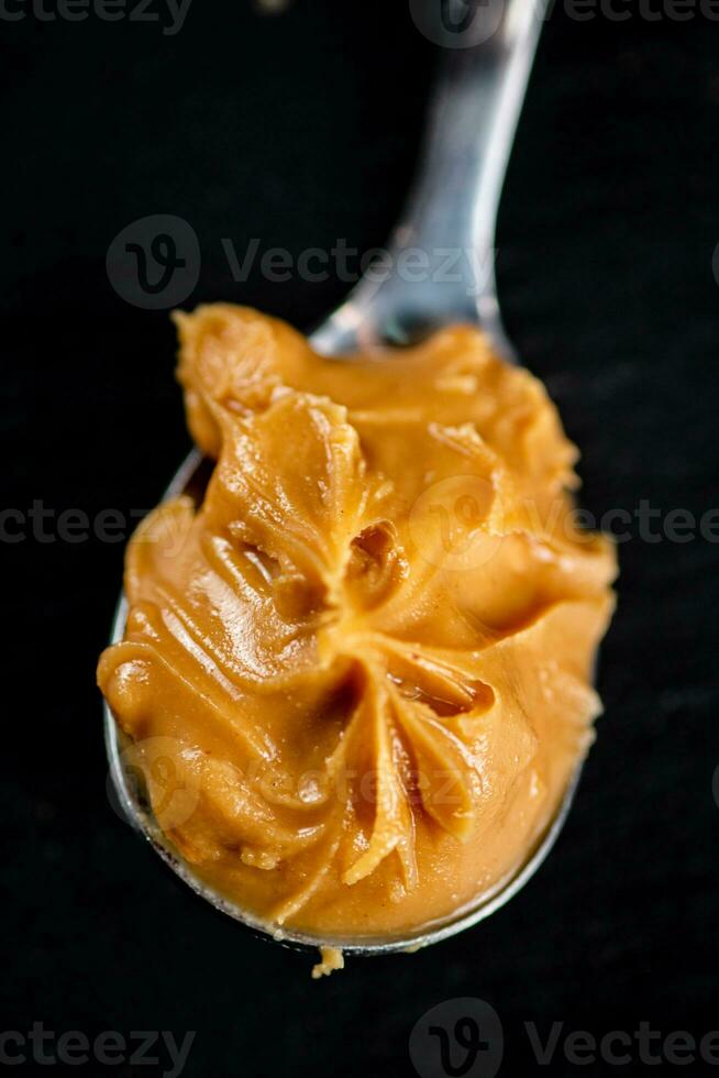 A spoonful full of peanut butter. photo