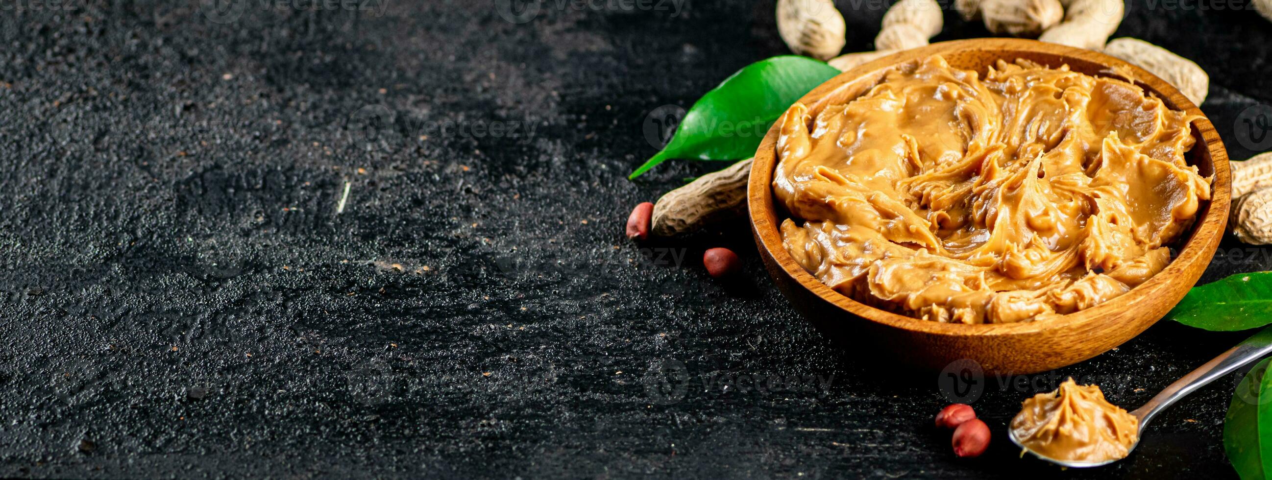 Peanut butter in a plate and spoon. photo