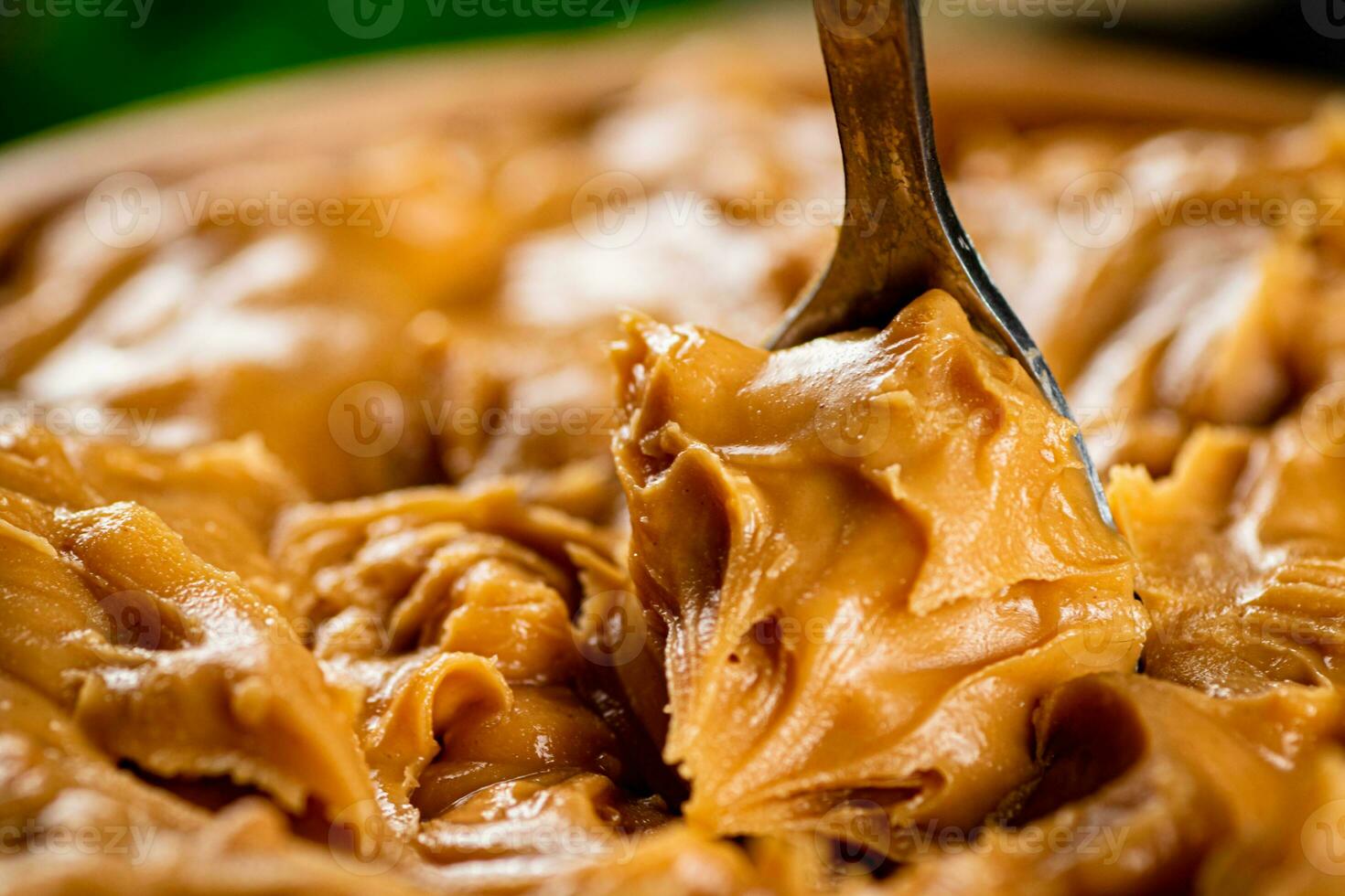 The spoon is in peanut butter. photo