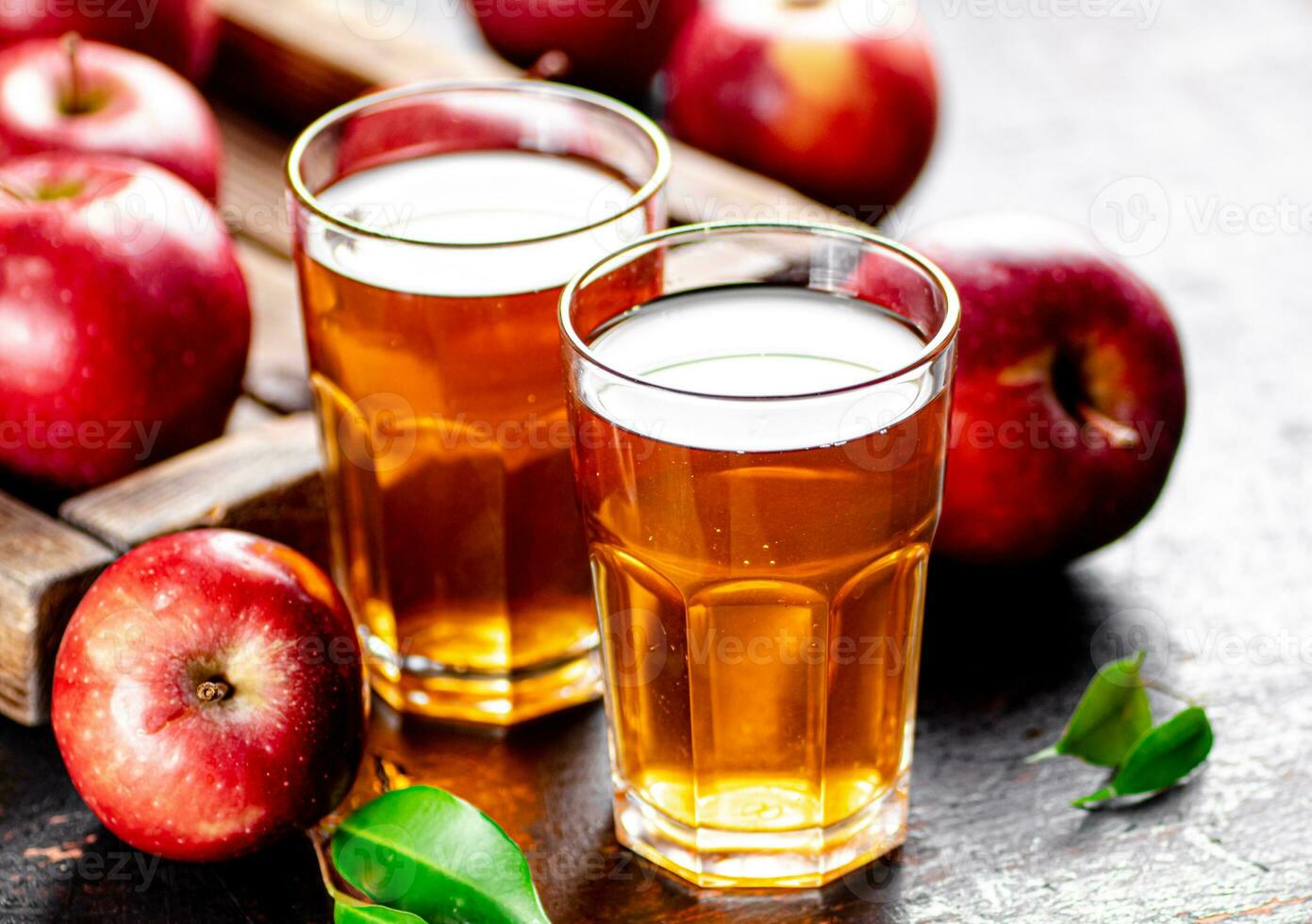 A glass of apple juice on the table. photo