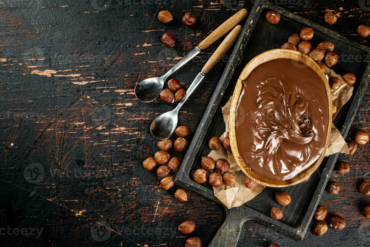 Hazelnut butter in a plate on a cutting board with paper. photo