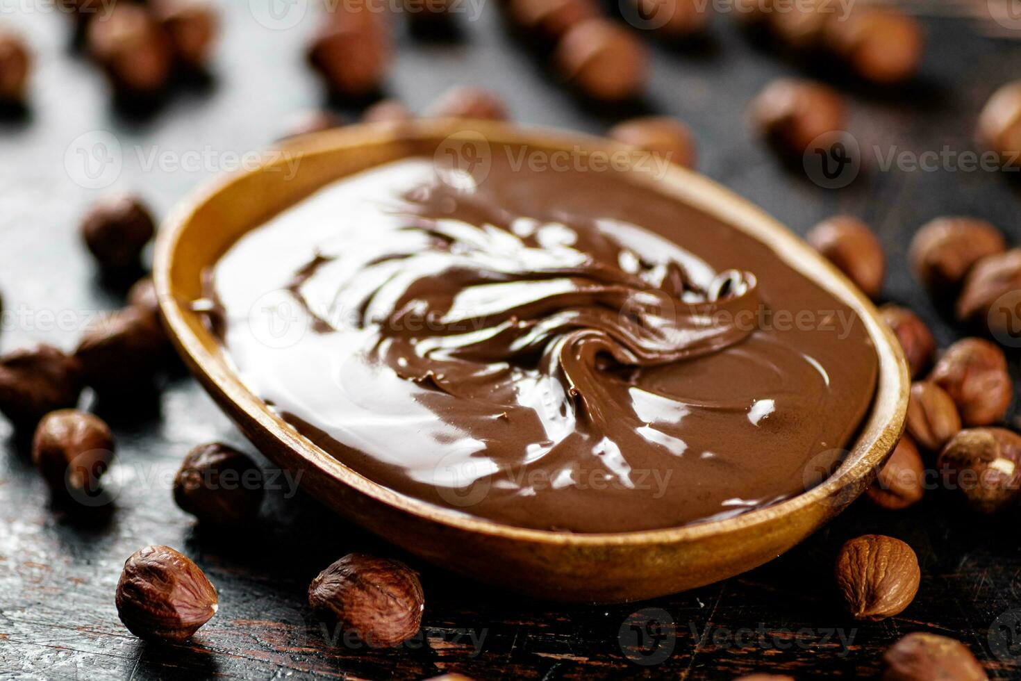 Hazelnut butter with peeled hazelnuts on the table. photo