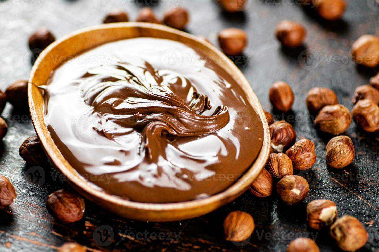 Hazelnut butter with peeled hazelnuts on the table. photo