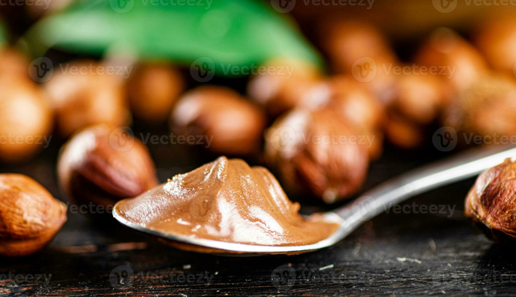 Hazelnut butter in a spoon on the table. photo