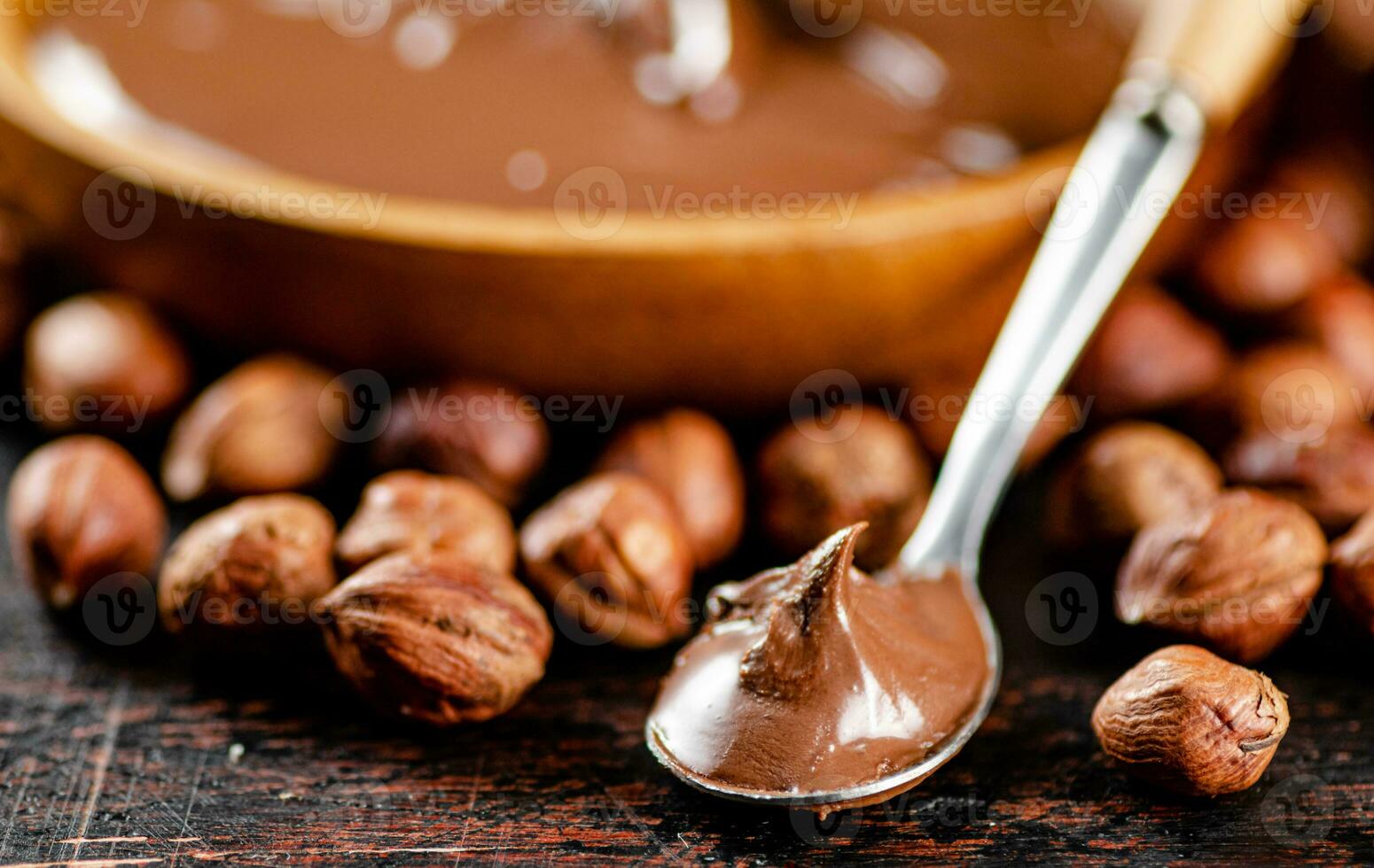 Hazelnut butter in a spoon on the table. photo