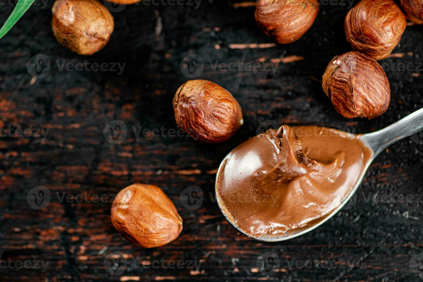 Hazelnut butter in a spoon on the table. photo