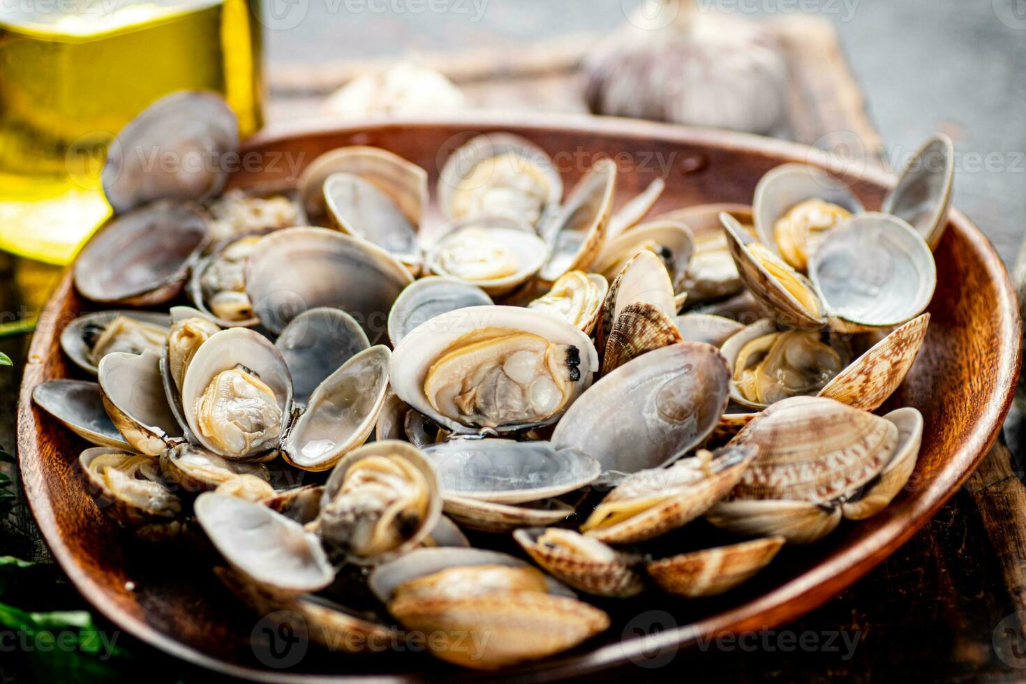 A wooden plate full of fresh vongole. photo