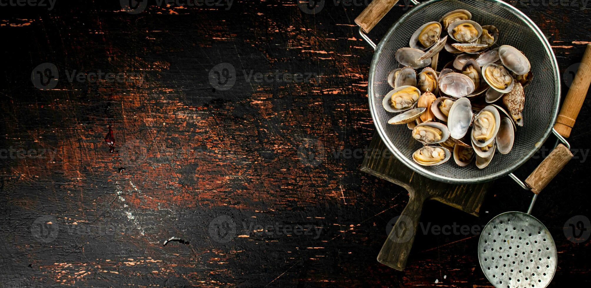 Vongole in a colander on a cutting board. photo