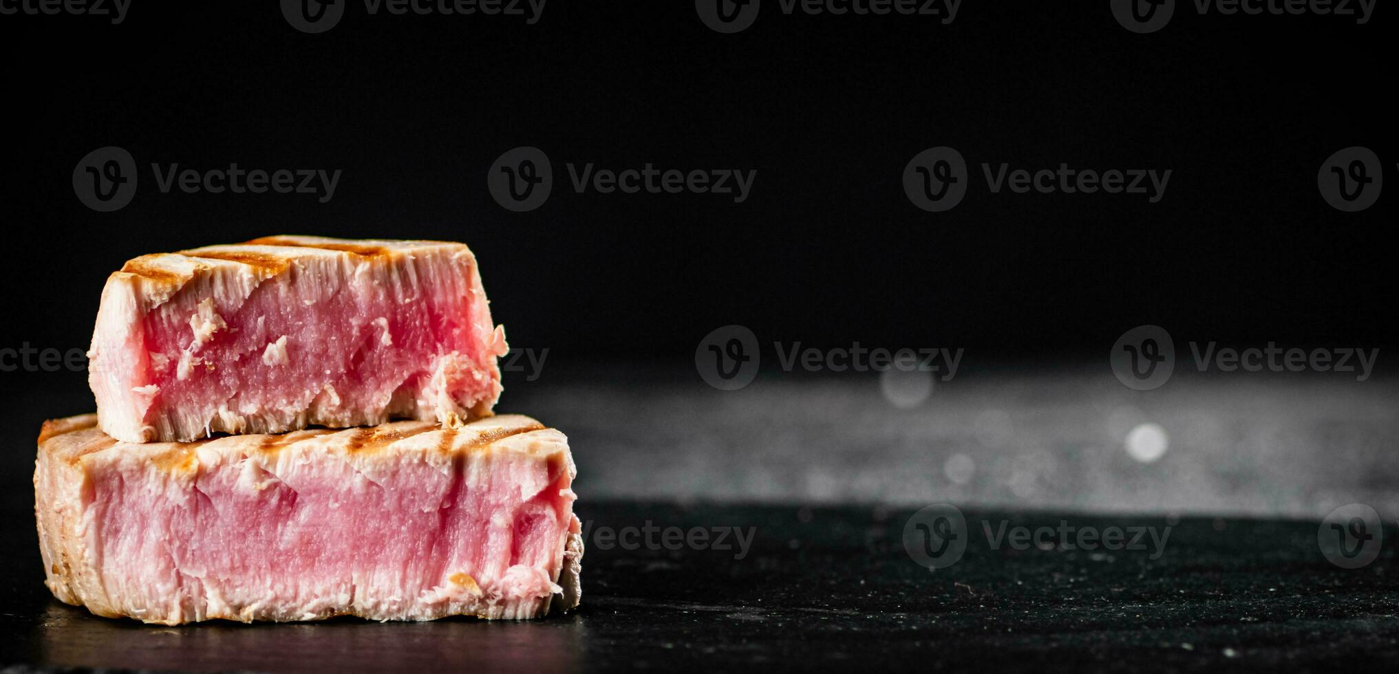 Grilled tuna steak on the table. photo