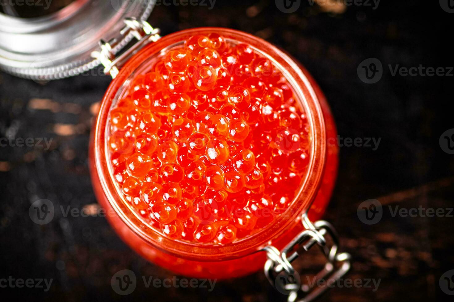 Delicious red caviar in a glass jar. photo