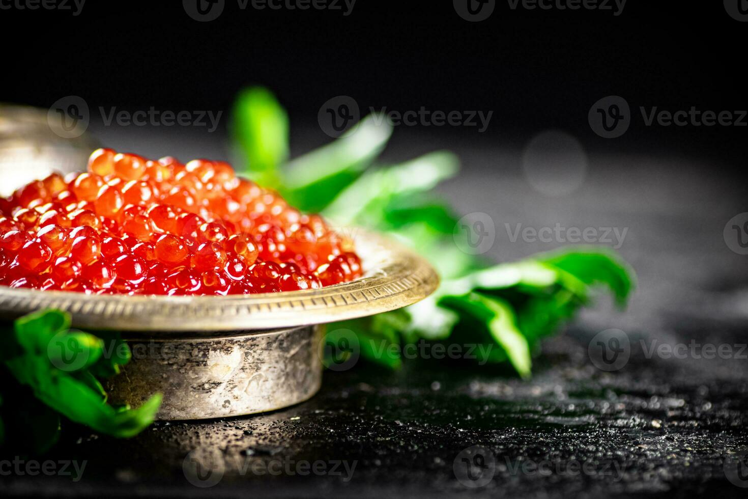 Full bowl of red caviar on the table. photo