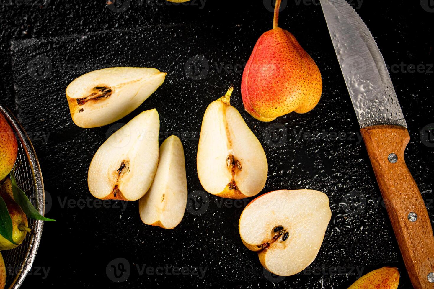 Sliced ripe pear with a knife. photo