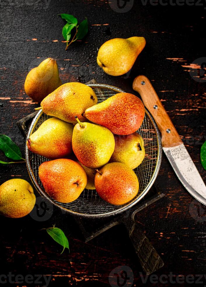 Ripe pears in a colander. photo