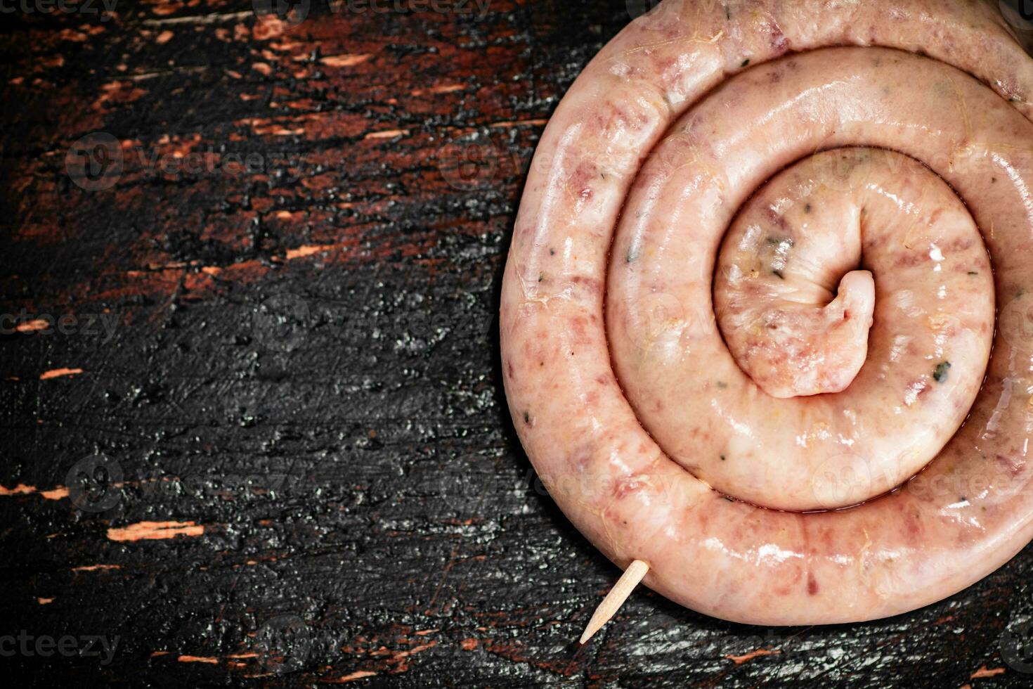 Raw sausage for frying on the table. photo