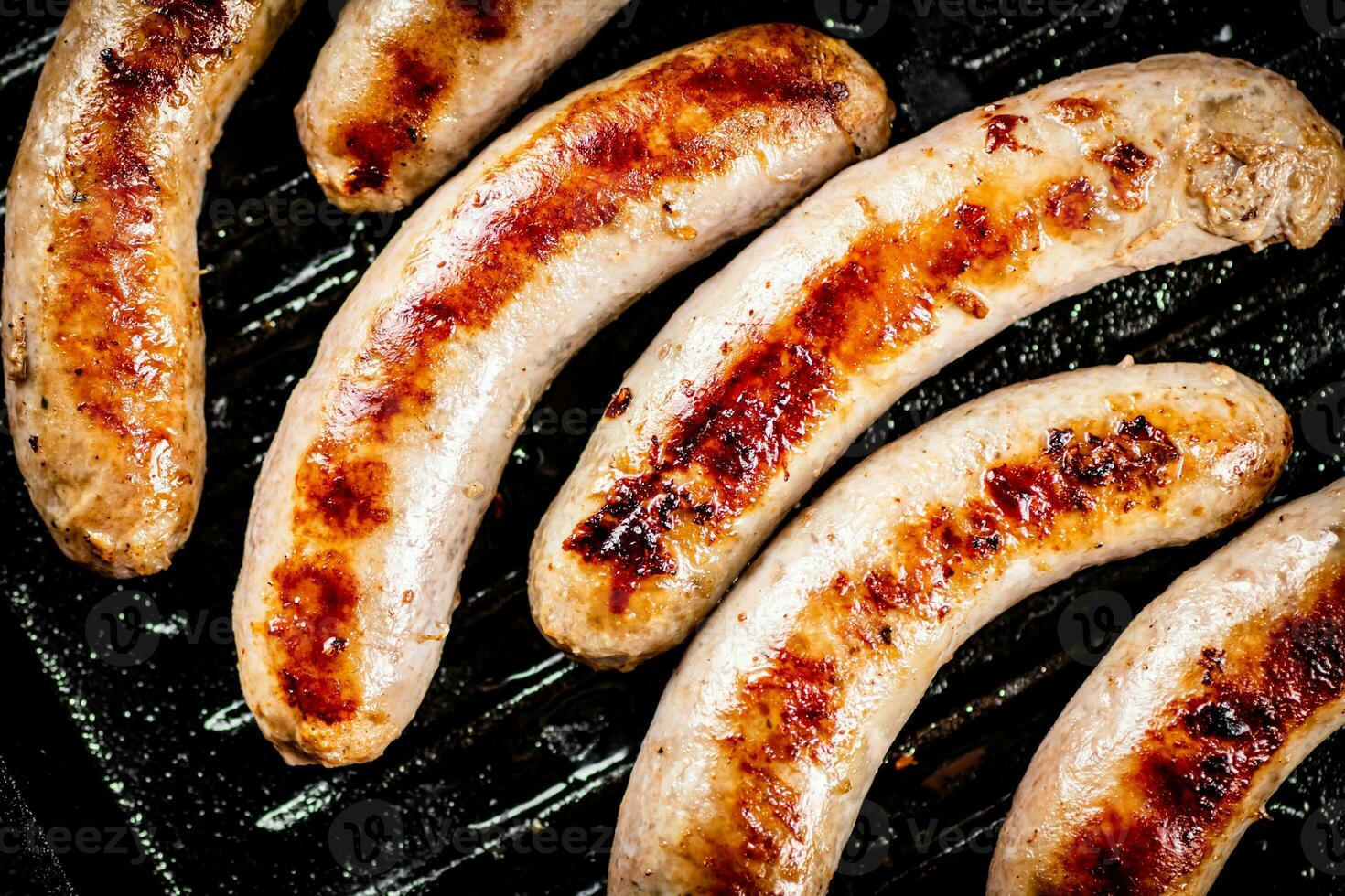 Grilled sausages in a frying pan. photo