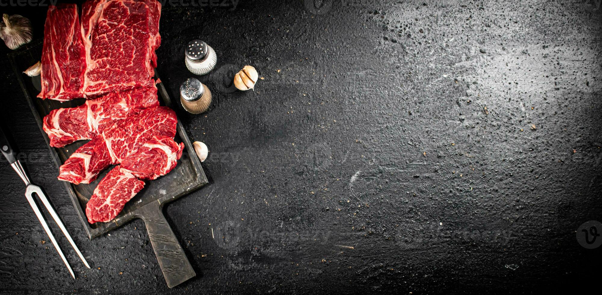 Raw beef on a cutting board. photo