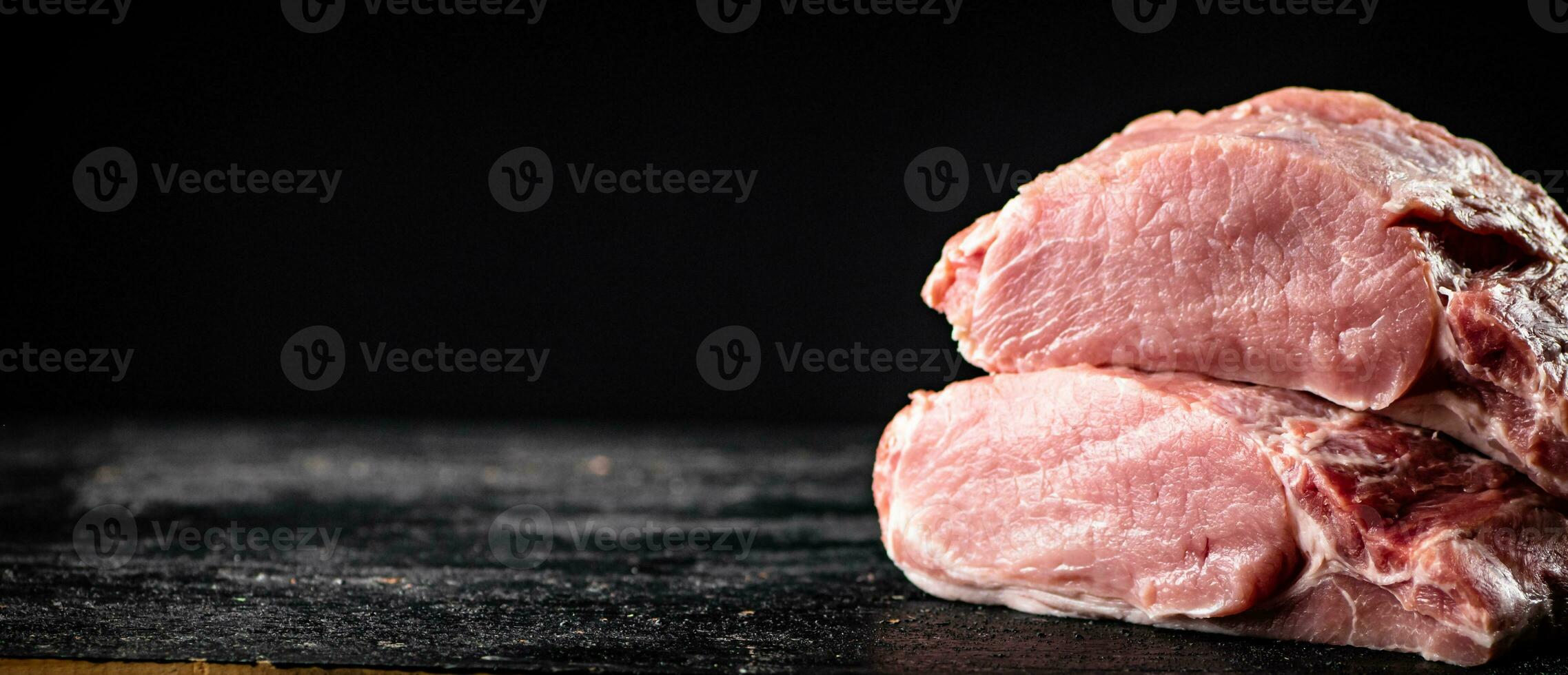 Pieces of raw pork on the table. photo
