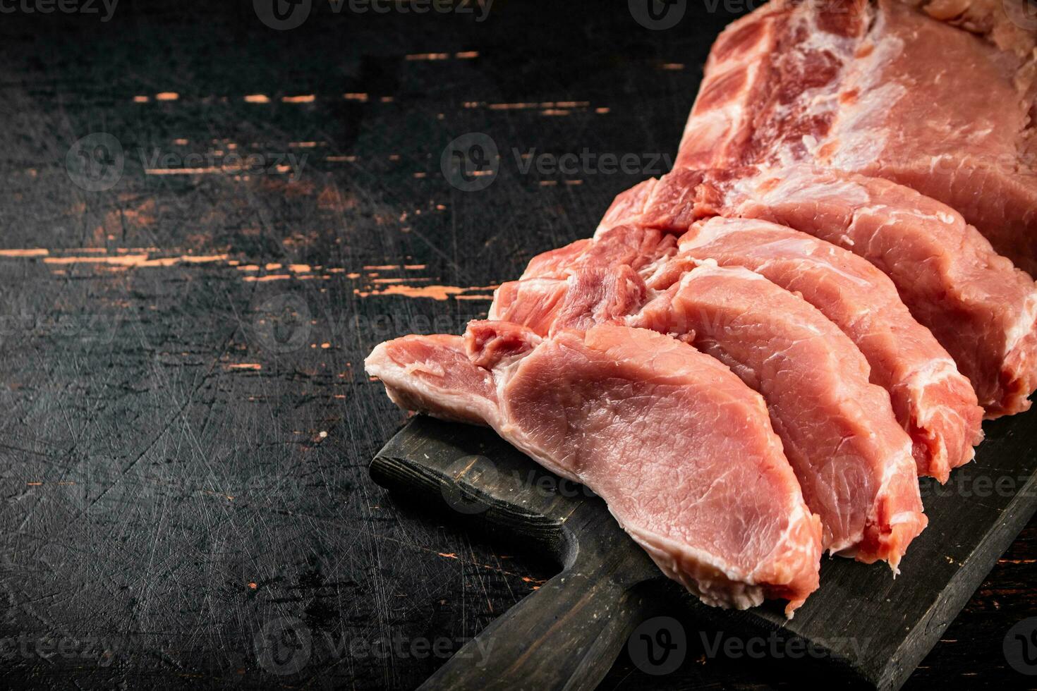 Raw pork on a cutting board. photo