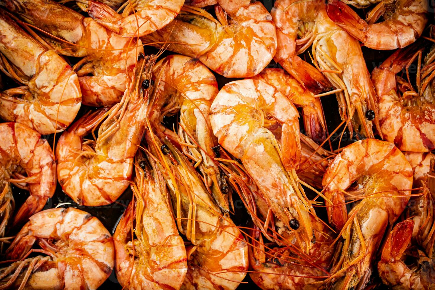 Red shrimp are boiled in water. Macro background. photo