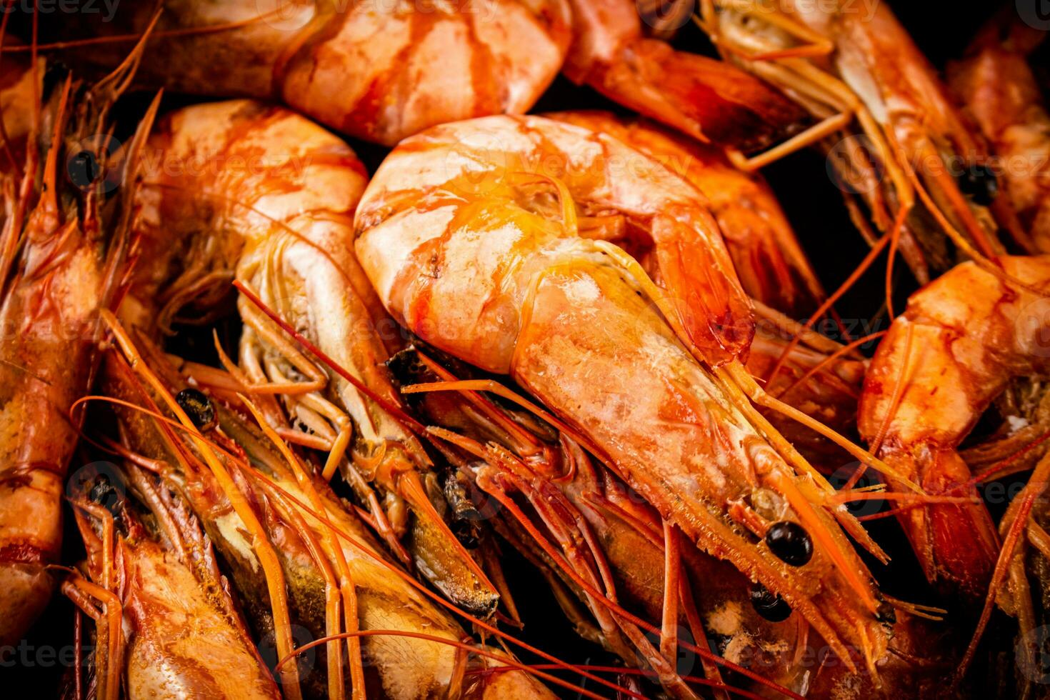Red shrimp are boiled in water. Macro background. photo
