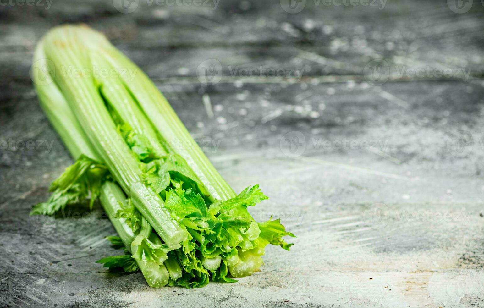 A stalk of fresh celery on the table. photo