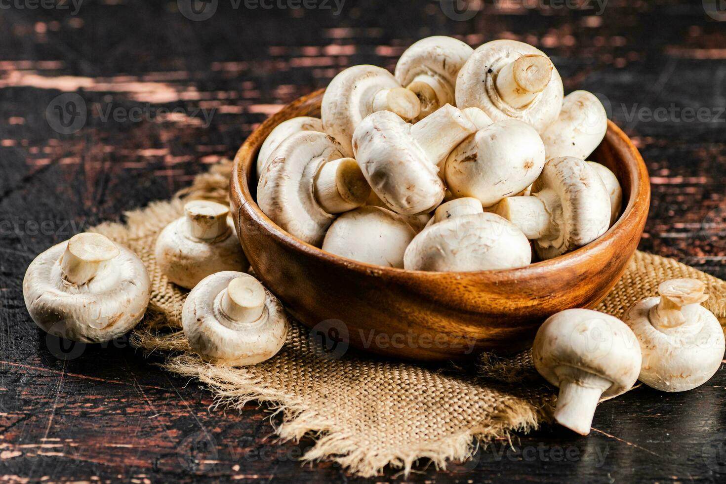 Mushrooms in a wooden plate on a napkin. photo