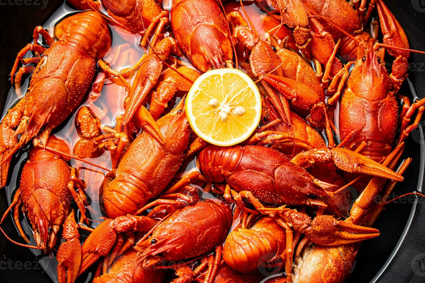 Crayfish are boiled in a pot in water. photo