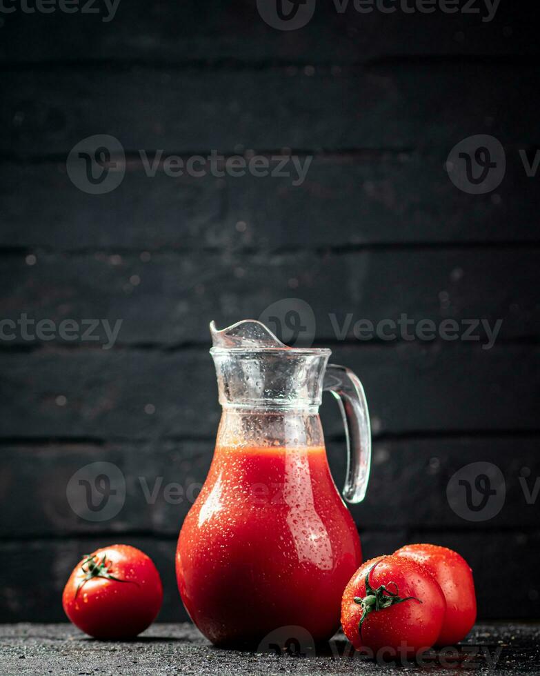 Fresh tomato juice in a jug. photo