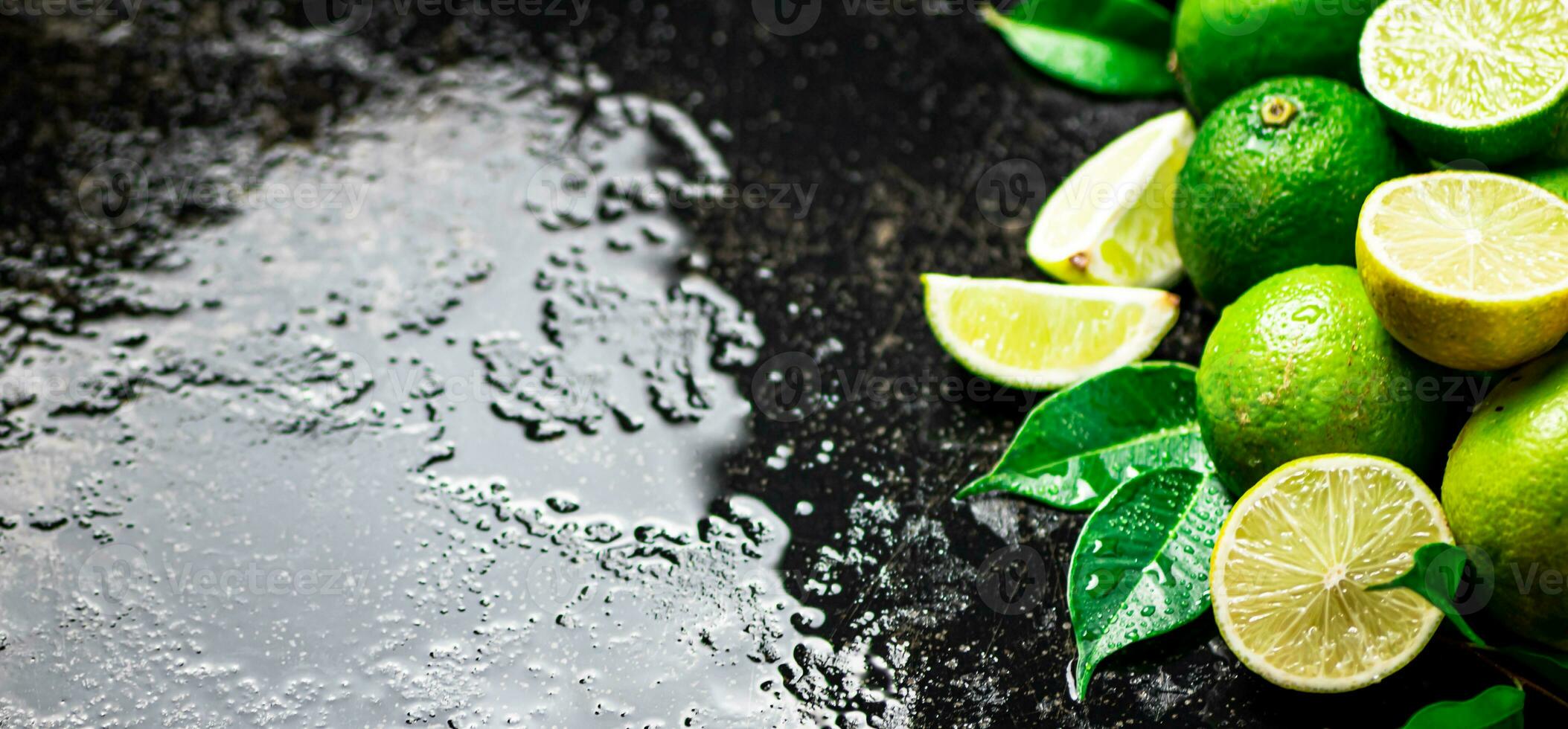 Pieces and whole lime with leaves. photo