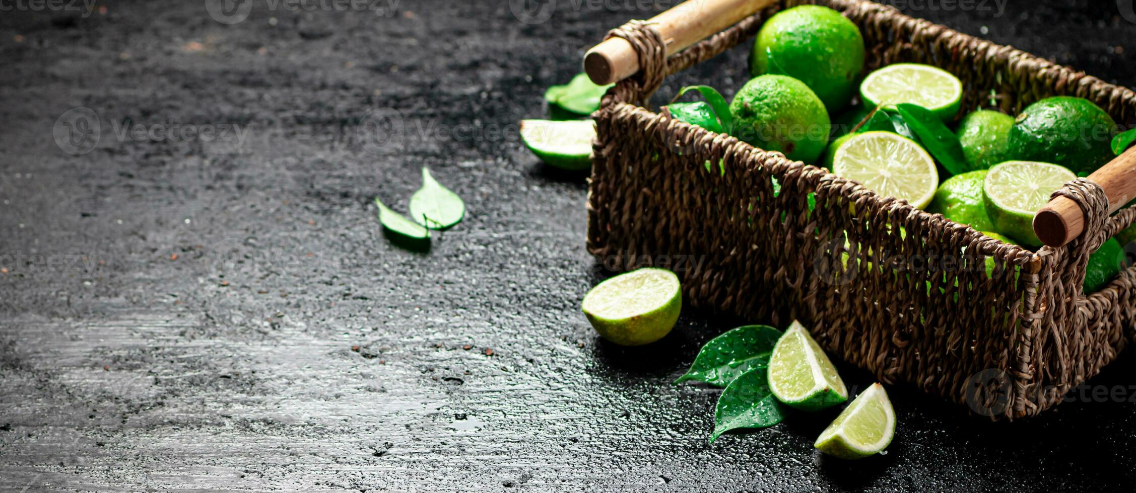 Lime with leaves in a basket. photo