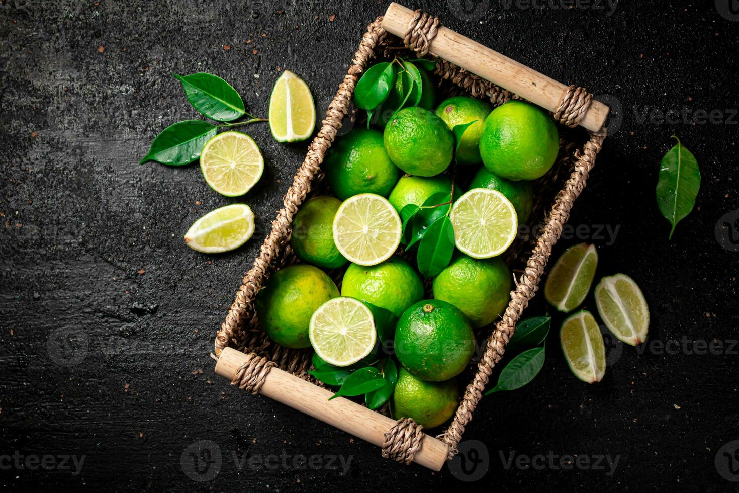 Lime with leaves in a basket. photo
